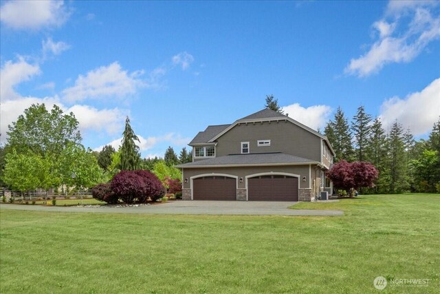 31045 219th Way SE, Black Diamond, WA 98010 - view of home's exterior with stone siding, a garage, a yard, driveway, and central air condition unit