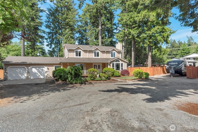 7611 176th Ave E, Bonney Lake, WA 98391 - traditional home featuring a chimney, driveway, a garage, a porch, and roof with shingles
