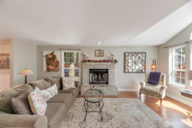 7611 176th Ave E, Bonney Lake, WA 98391 - living area with wood finished floors, baseboards, and a fireplace with raised hearth