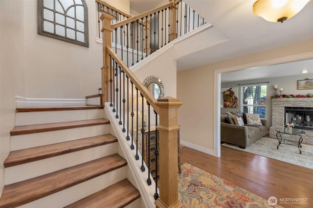 7611 176th Ave E, Bonney Lake, WA 98391 - stairway featuring wood finished floors, baseboards, and a fireplace