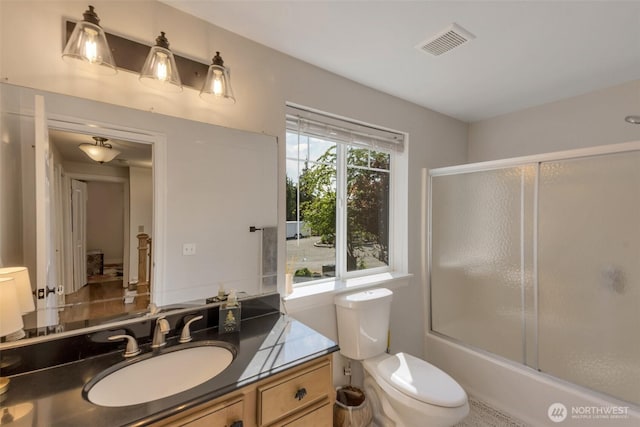 7611 176th Ave E, Bonney Lake, WA 98391 - bathroom featuring vanity, toilet, and bath / shower combo with glass door