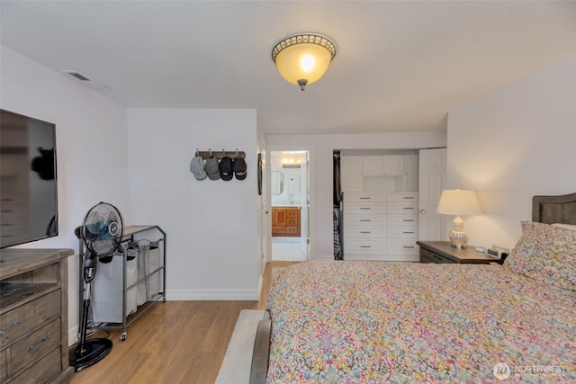 7611 176th Ave E, Bonney Lake, WA 98391 - bedroom with light wood finished floors, baseboards, and ensuite bath
