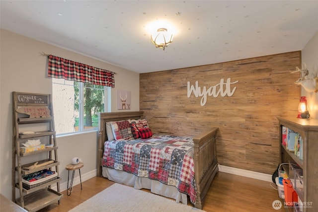 7611 176th Ave E, Bonney Lake, WA 98391 - bedroom featuring wooden walls, baseboards, and wood finished floors