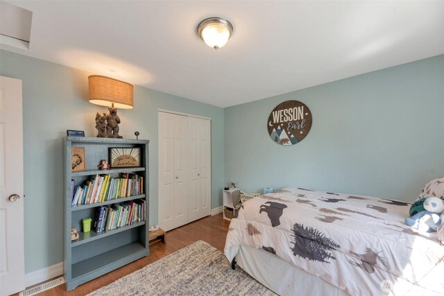 7611 176th Ave E, Bonney Lake, WA 98391 - bedroom featuring a closet, wood finished floors, and baseboards