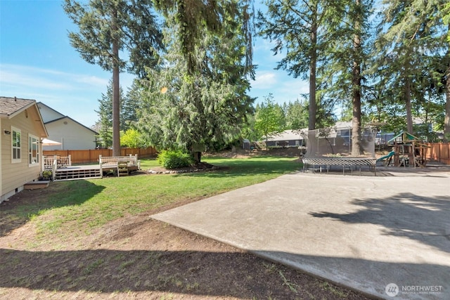 7611 176th Ave E, Bonney Lake, WA 98391 - view of yard with a trampoline, a playground, and a deck