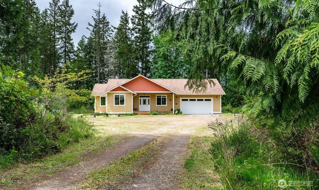 single story home featuring driveway and a garage