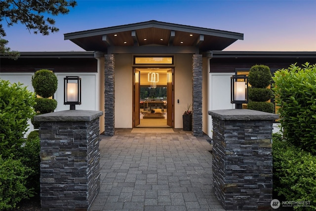 8926 NE 36th St, Yarrow Point, WA 98004 - exterior entry at dusk featuring stucco siding and stone siding