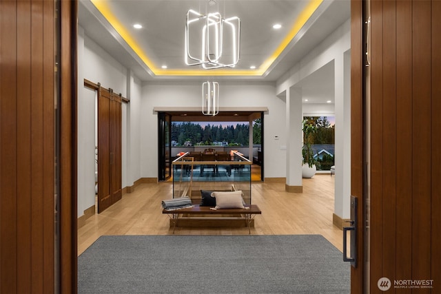 8926 NE 36th St, Yarrow Point, WA 98004 - home theater room featuring a barn door, a chandelier, a tray ceiling, wood finished floors, and recessed lighting