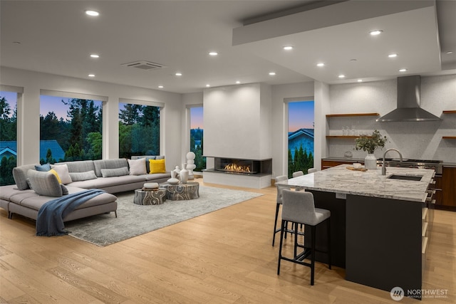 8926 NE 36th St, Yarrow Point, WA 98004 - living room featuring light wood-style floors, a multi sided fireplace, and recessed lighting