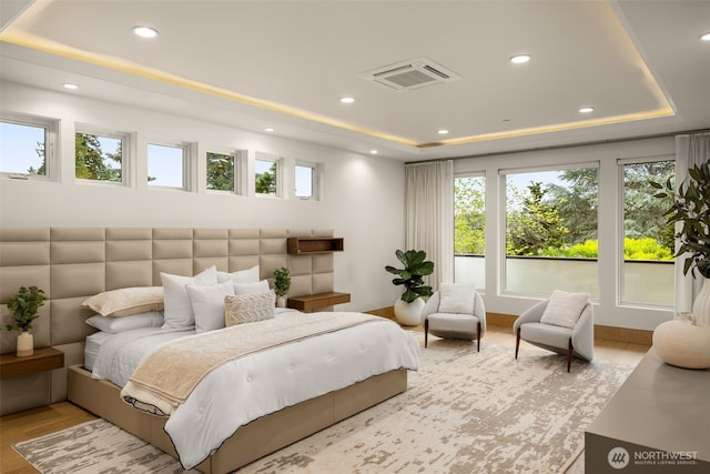8926 NE 36th St, Yarrow Point, WA 98004 - bedroom featuring a tray ceiling, multiple windows, recessed lighting, and light wood-type flooring