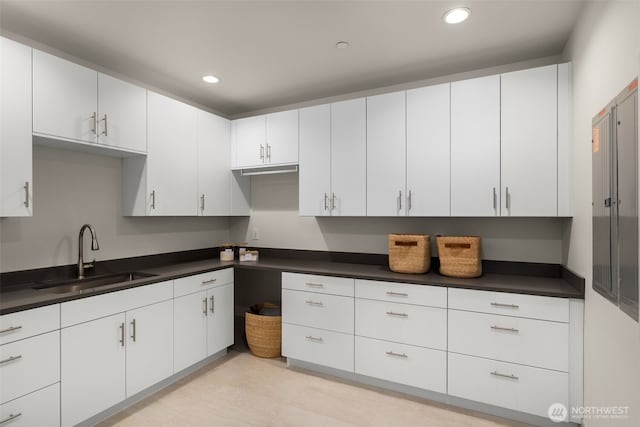 8926 NE 36th St, Yarrow Point, WA 98004 - kitchen featuring a sink, dark countertops, recessed lighting, and white cabinetry