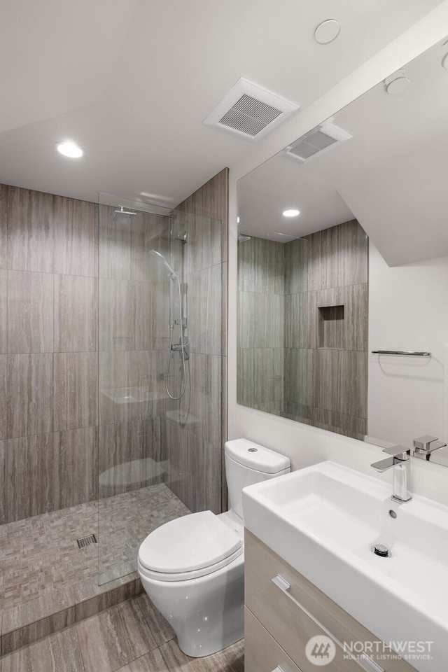 8926 NE 36th St, Yarrow Point, WA 98004 - full bath featuring toilet, walk in shower, vanity, recessed lighting, and wood finished floors