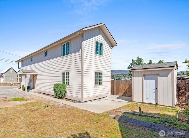 203 Marr St, Wenatchee, WA 98801 - back of property with a storage shed, fence, an outbuilding, and a patio