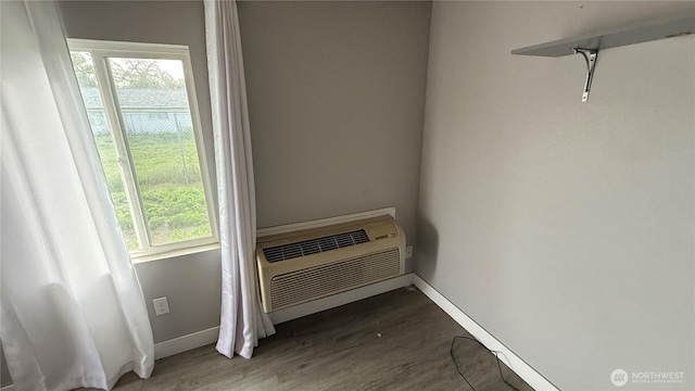 47 SE 10th St, College Place, WA 99324 - detailed view of baseboards, wood finished floors, and a wall mounted air conditioner