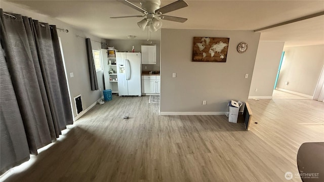 47 SE 10th St, College Place, WA 99324 - unfurnished living room featuring a ceiling fan, light wood finished floors, baseboards, and plenty of natural light