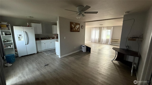 47 SE 10th St, College Place, WA 99324 - unfurnished living room featuring wood finished floors, a ceiling fan, a sink, and baseboards