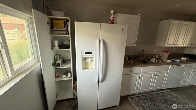 47 SE 10th St, College Place, WA 99324 - kitchen with white appliances, a sink, wood finished floors, white cabinets, and dark countertops