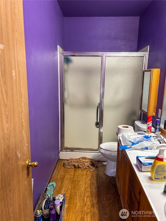 19904 13th Avenue Ct E, Spanaway, WA 98387 - bathroom with toilet, a stall shower, vanity, and wood finished floors