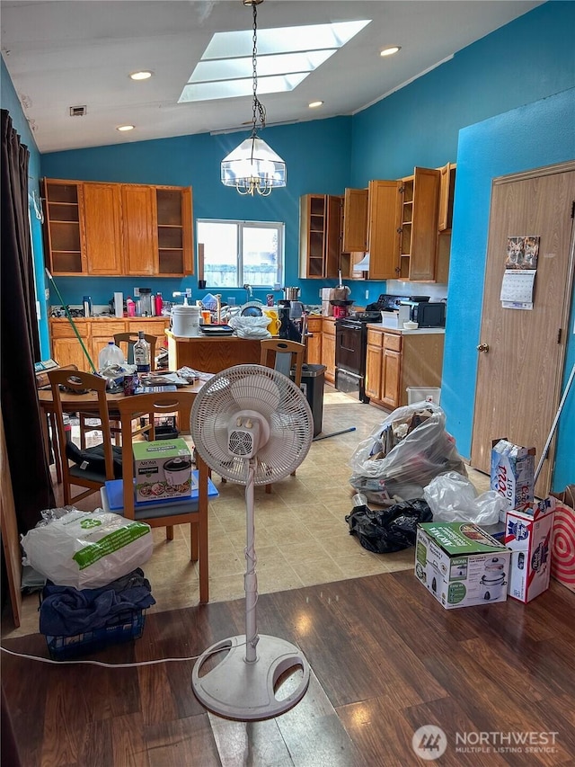 19904 13th Avenue Ct E, Spanaway, WA 98387 - kitchen featuring open shelves, lofted ceiling, black electric range oven, a skylight, and brown cabinetry