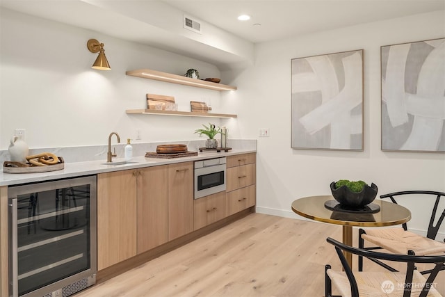 11320 113th Pl NE, Kirkland, WA 98033 - indoor wet bar with beverage cooler, light wood-style flooring, baseboards, and recessed lighting