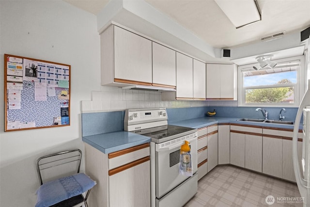 513 K St SW, Quincy, WA 98848 - kitchen featuring white appliances, a sink, light flooring, and tasteful backsplash