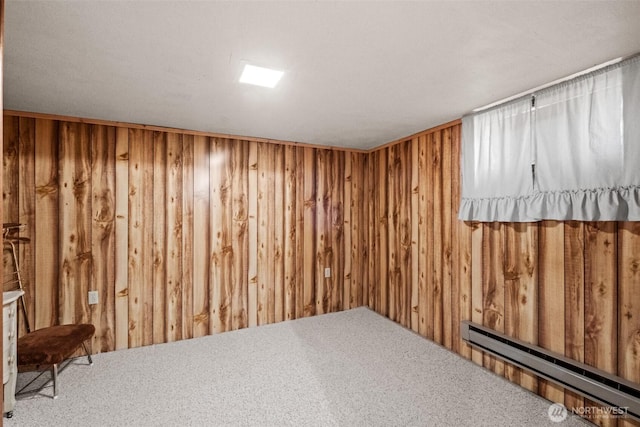 513 K St SW, Quincy, WA 98848 - finished below grade area featuring wood walls, a baseboard radiator, and carpet