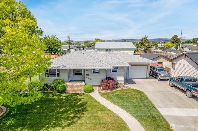 513 K St SW, Quincy, WA 98848 - view of front of home featuring driveway, an attached garage, a shingled roof, a front yard, and a residential view