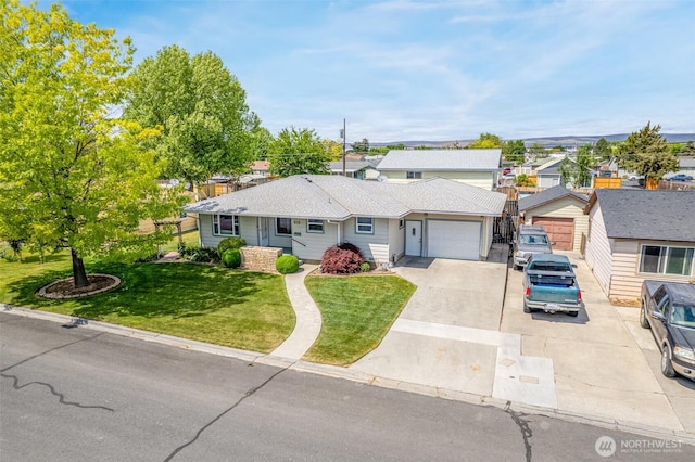 513 K St SW, Quincy, WA 98848 - ranch-style home featuring driveway, an attached garage, a front lawn, and a residential view