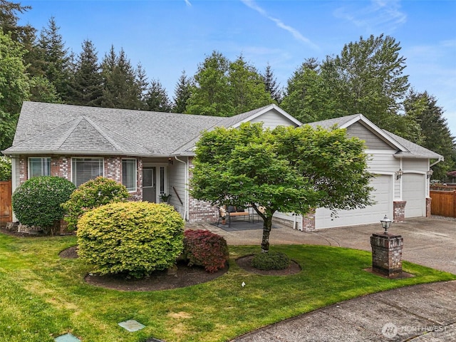 20616 193rd Avenue Ct E, Orting, WA 98360 - view of front of home with an attached garage, concrete driveway, brick siding, and a shingled roof