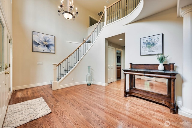 20524 73rd Dr SE, Snohomish, WA 98296 - foyer entrance featuring stairs, wood finished floors, baseboards, a chandelier, and a towering ceiling