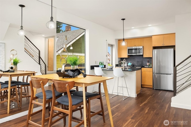 3818 S Hudson St Unit A, Seattle, WA 98118 - kitchen with stainless steel appliances, dark wood-style floors, backsplash, dark countertops, and recessed lighting