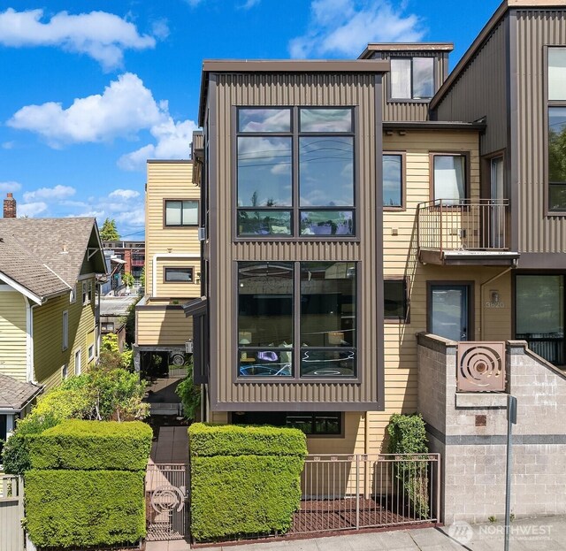 3818 S Hudson St Unit A, Seattle, WA 98118 - view of front of property with board and batten siding and a gate