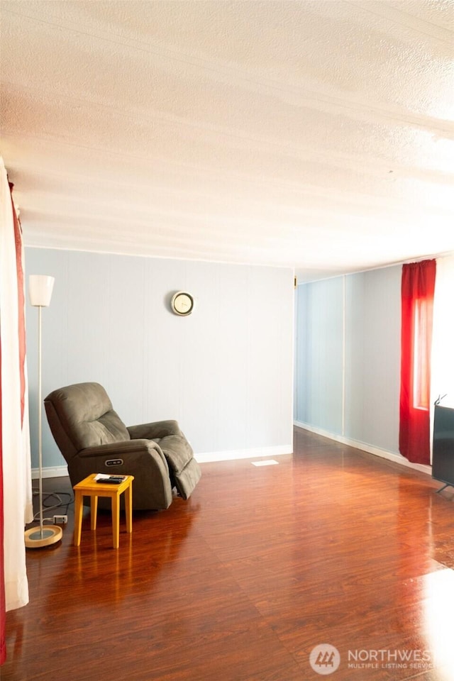 3333 SE 228th St Unit 105, Bothell, WA 98021 - sitting room with wood finished floors, a textured ceiling, and baseboards