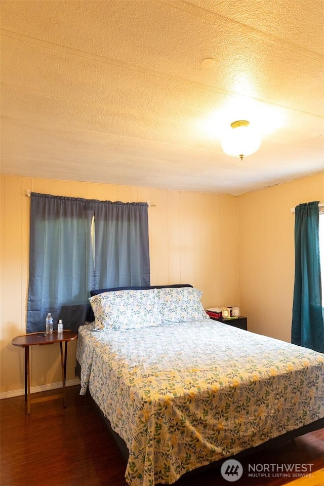3333 SE 228th St Unit 105, Bothell, WA 98021 - bedroom with dark wood-style flooring and baseboards