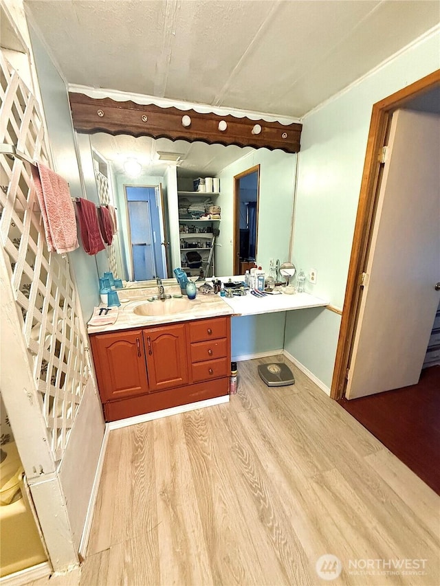 3333 SE 228th St Unit 105, Bothell, WA 98021 - bathroom featuring wood finished floors, vanity, and baseboards