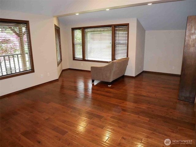 unfurnished room with baseboards and hardwood / wood-style flooring