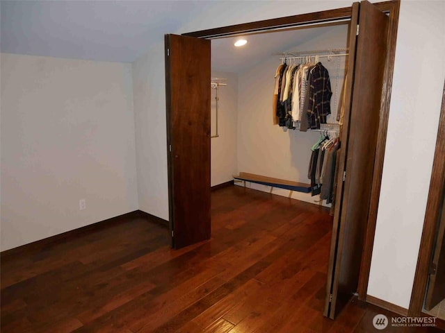 interior space with wood finished floors, recessed lighting, and baseboards