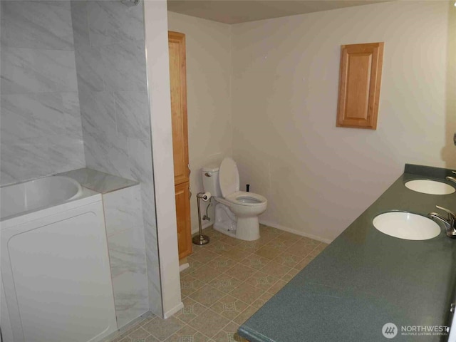 full bathroom with toilet and double vanity