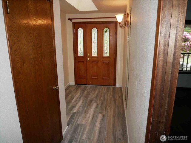 foyer with wood finished floors and baseboards
