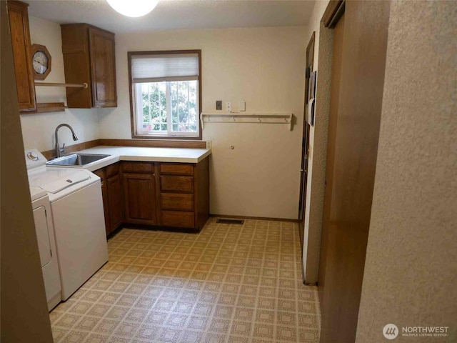 washroom with cabinet space, washer and dryer, and light flooring