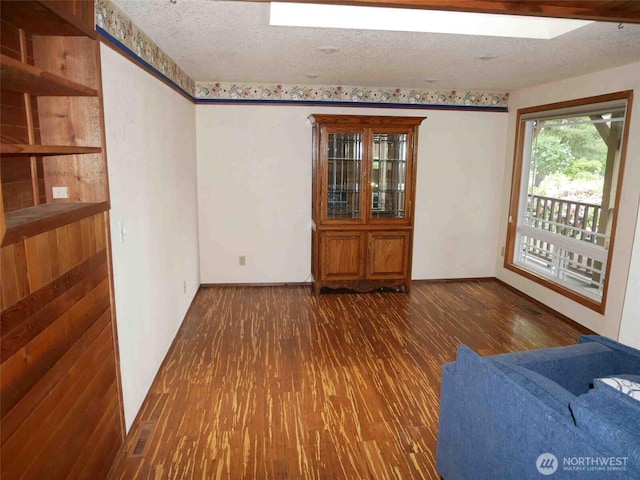 empty room featuring wood finished floors and a textured ceiling