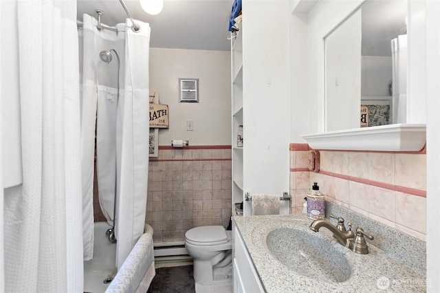 187 S A St, Buckley, WA 98321 - bathroom with tile walls, a baseboard radiator, vanity, toilet, and wainscoting