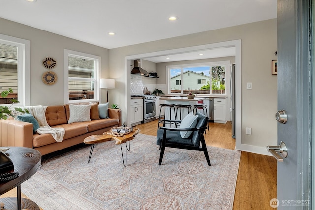 9419 39th Ave S, Seattle, WA 98118 - living area featuring healthy amount of natural light, light wood-style floors, recessed lighting, and baseboards