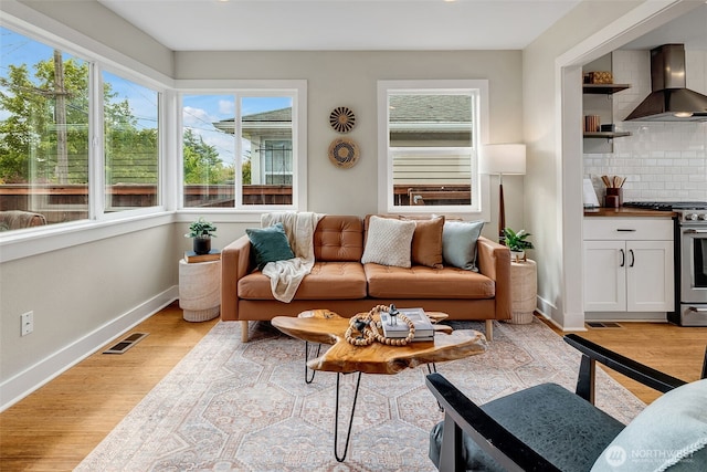 9419 39th Ave S, Seattle, WA 98118 - living room with plenty of natural light, baseboards, and light wood-style flooring