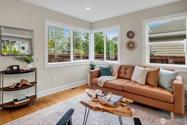 9419 39th Ave S, Seattle, WA 98118 - living room featuring healthy amount of natural light, baseboards, wood finished floors, and recessed lighting