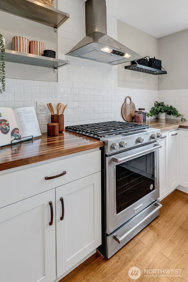 9419 39th Ave S, Seattle, WA 98118 - kitchen featuring stainless steel gas range oven, exhaust hood, wood counters, and open shelves