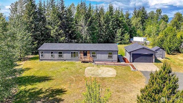 ranch-style house featuring an outdoor structure, board and batten siding, and a front yard