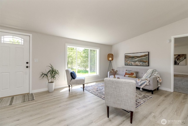 living area featuring light wood-style floors and baseboards