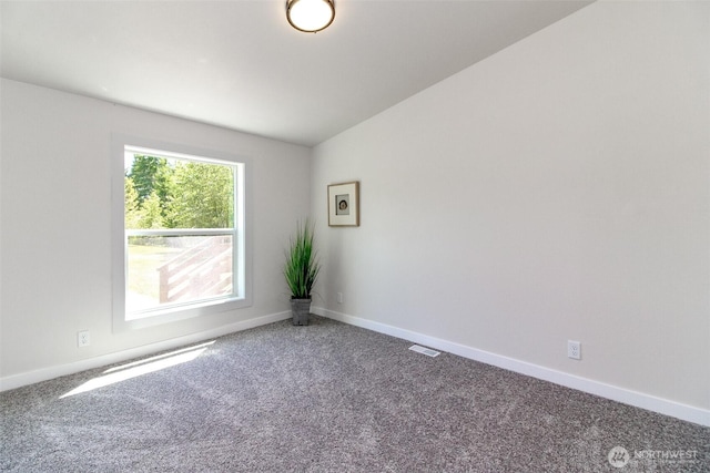 unfurnished room with carpet, baseboards, and lofted ceiling
