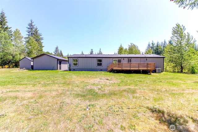 back of house featuring a wooden deck, a yard, and crawl space